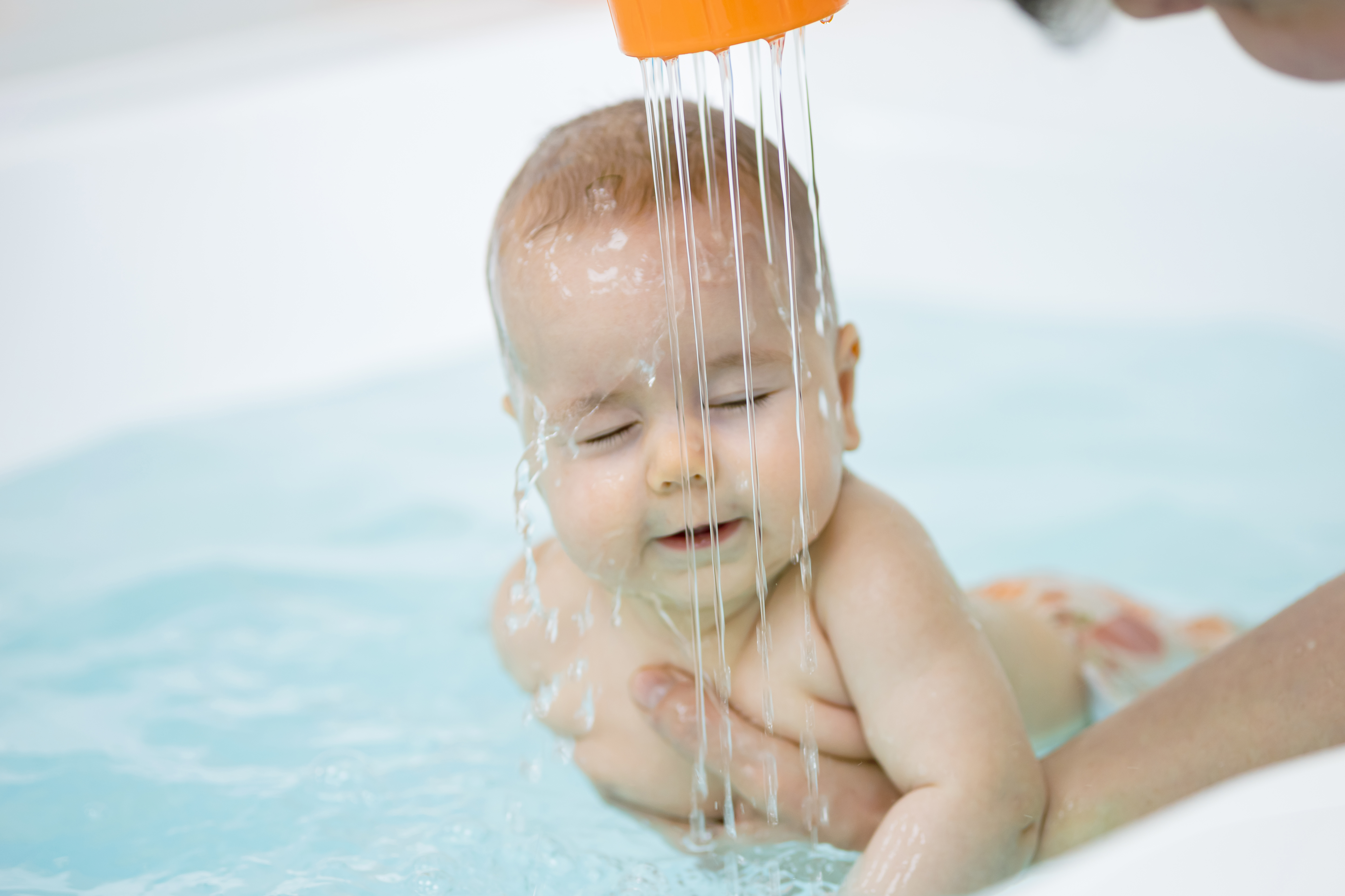 Baby Girl Splashes Hands And Kicks Legs Swimming Forward