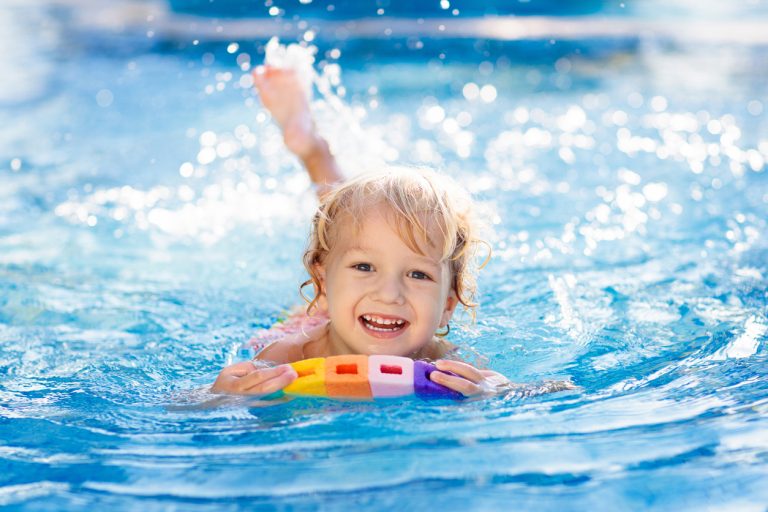 Child Learning To Swim. Kids In Swimming Pool.