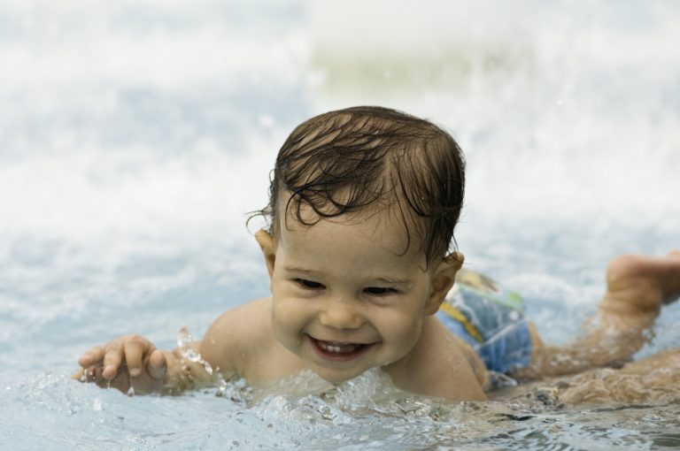 Smiling Baby In The Swimming Pool