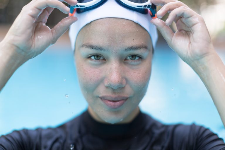 Portrait Of A Pretty Female Swimmer Athlete In The Pool.