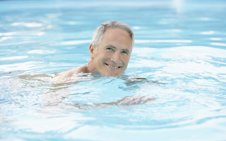 Happy Man Swimming In Pool