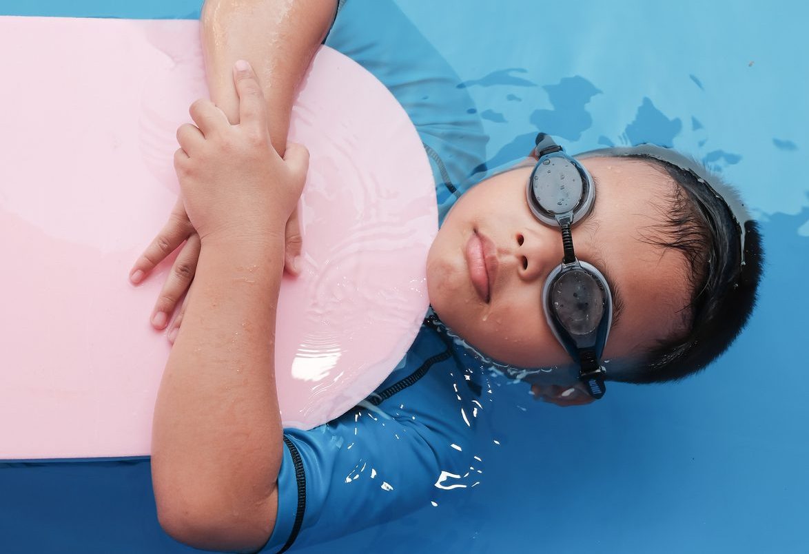 Boys Practice Swimming With Foam Pads.