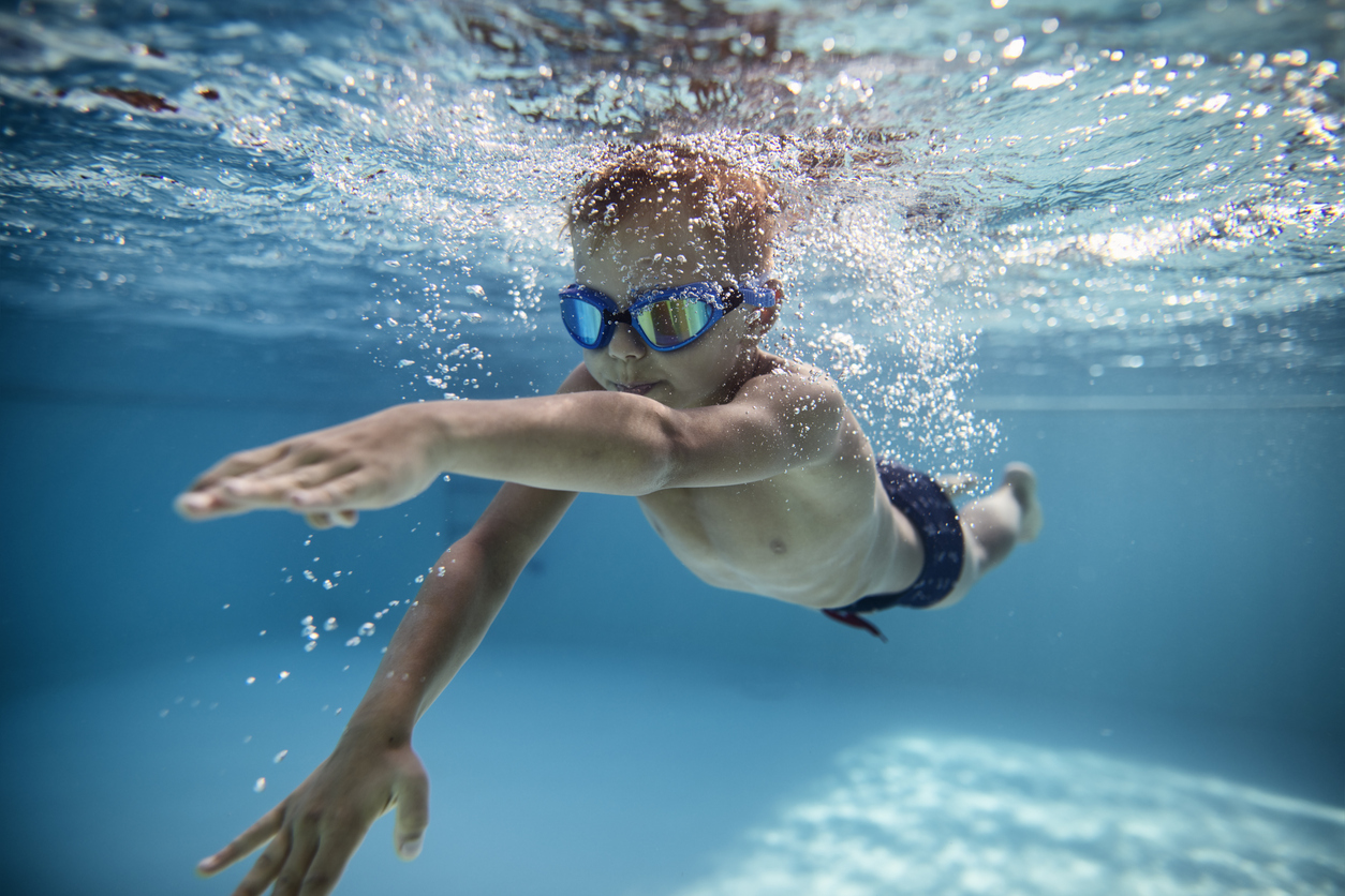 Little Boy Swimming Crawl In Pool